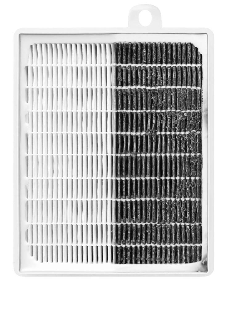 An air filter showing two sides: one side is clean and white, while the other side is dark and dirty, indicating its usage. The filter has a rectangular shape with pleated texture across both halves.